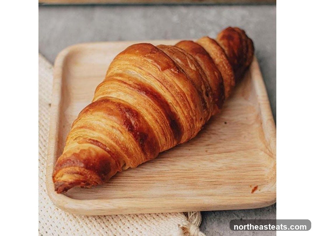 Croissant on a wooden tray