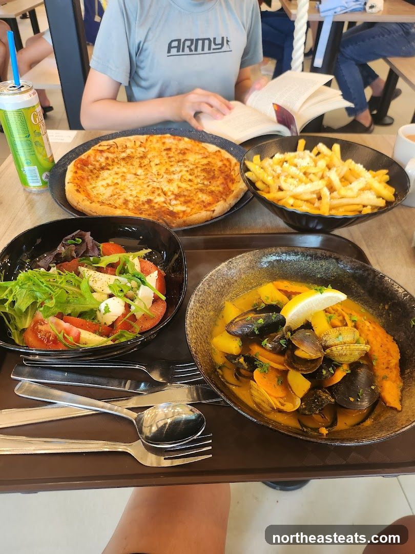 Meal with Pizza, Fries, Salad, and Seafood Stew
