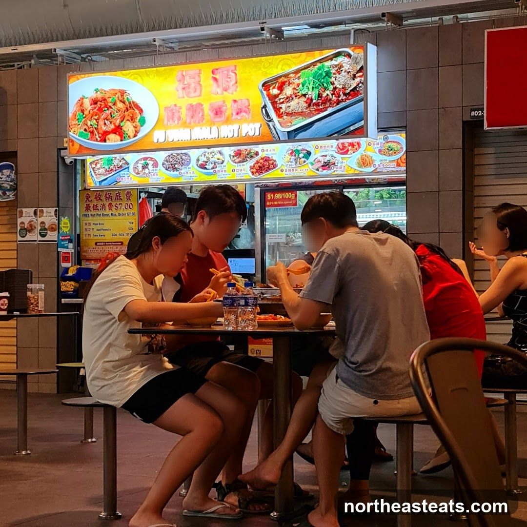 People eating at a food stall