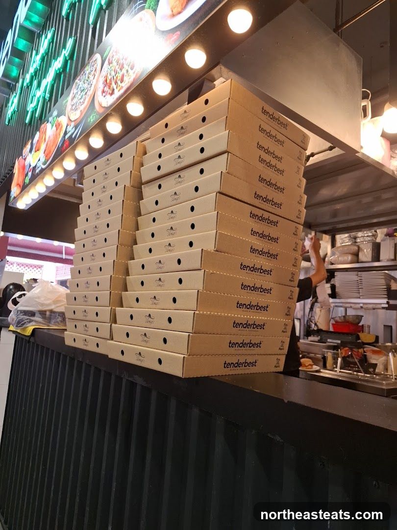 Pizza Boxes Stacked on Counter