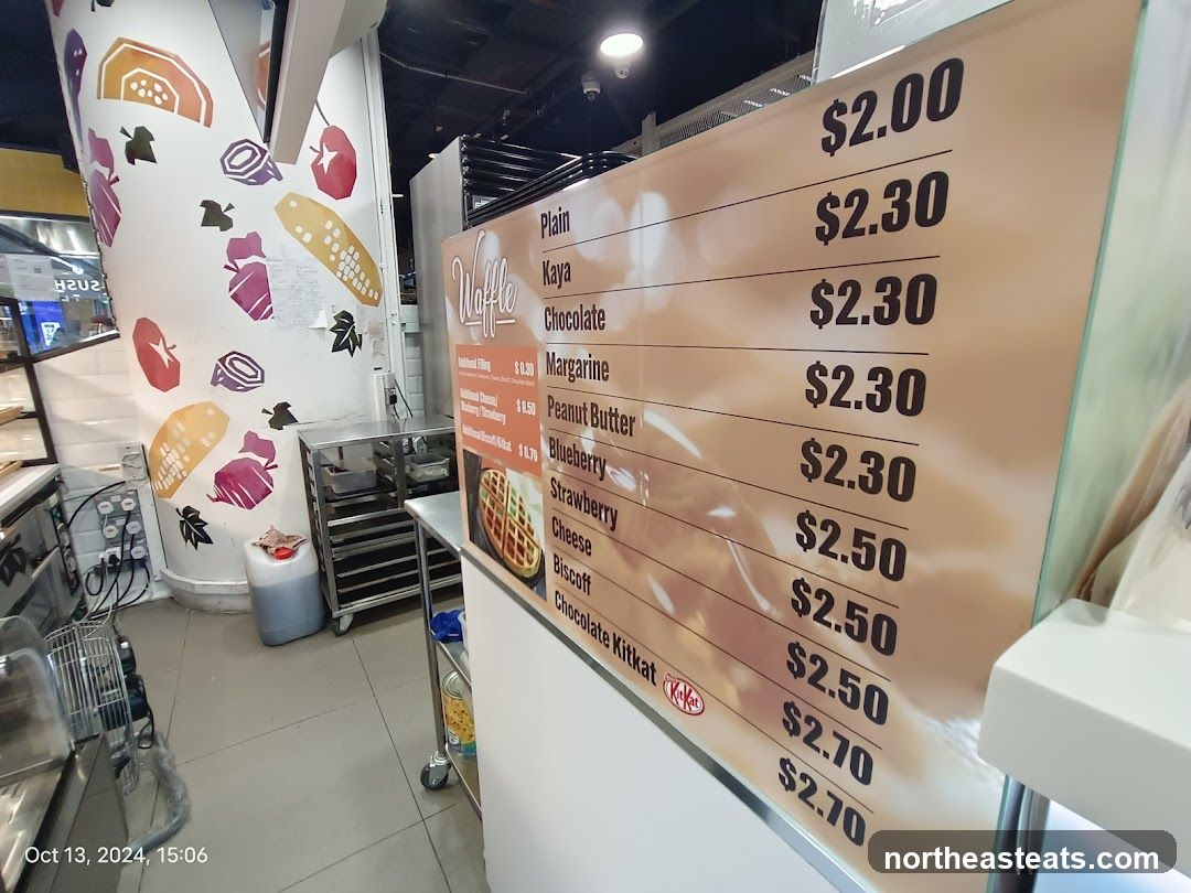 A menu board displaying waffle prices and additional fillings.