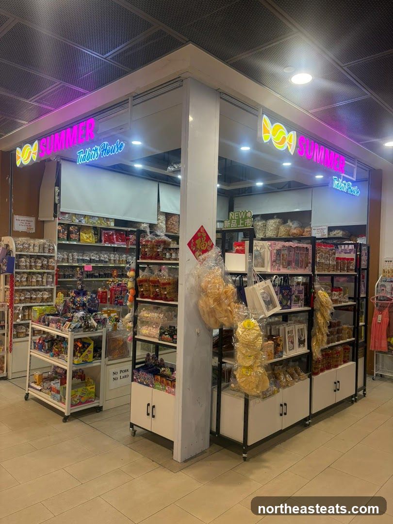 A brightly lit shop with neon signs that read "SUMMER Tidbits House" and a candy logo. The storefront displays shelves stocked with various snacks, candies, and toys.