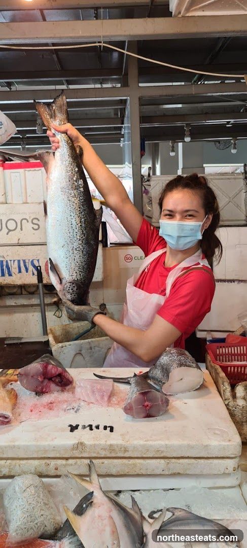 Fishmonger holding a large salmon