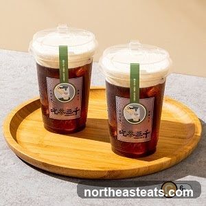 Two drinks on a wooden tray